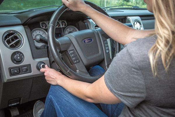 A user operates the Curt Spectrum Trailer Brake Controller, which is designed to provide more stable towing.