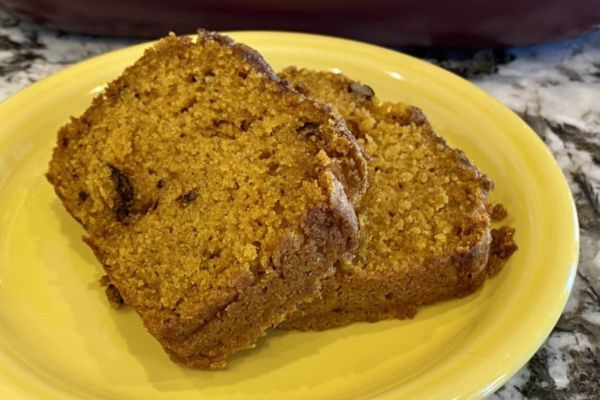 Two slices of pumpkin bread sliced on a plate
