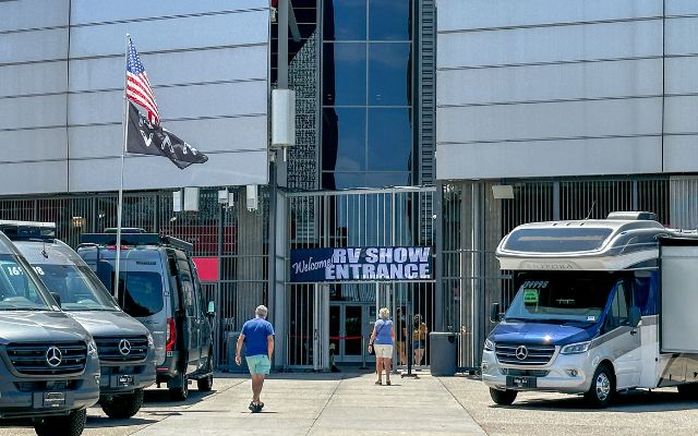 People outside the entrance of an RV show to buy the right RV.