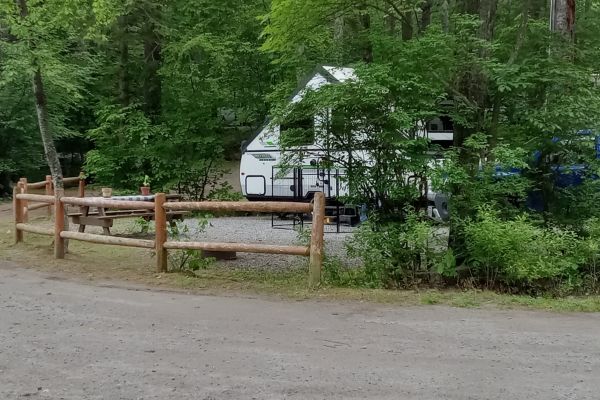 Campsite with A-frame, pop-up trailer.