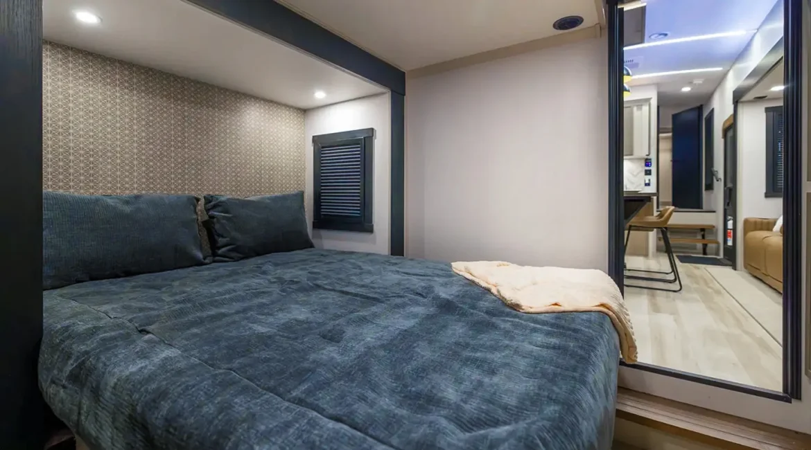 The rear queen bedroom in the quad-slideout Wildwood Heritage Glen 376FAM.